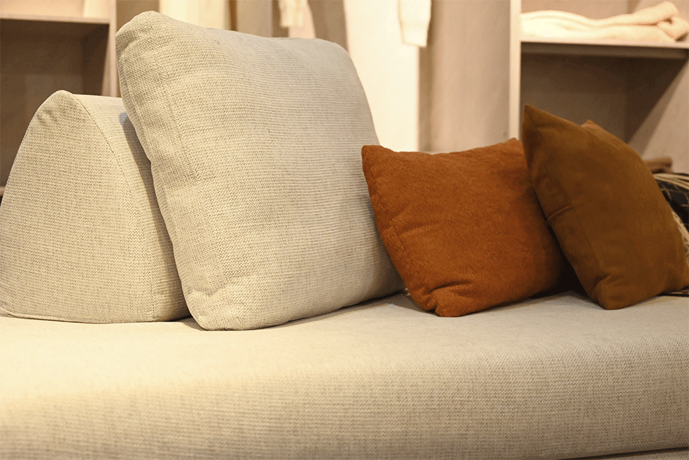 Beige sofa with decorative pillows in a home setting